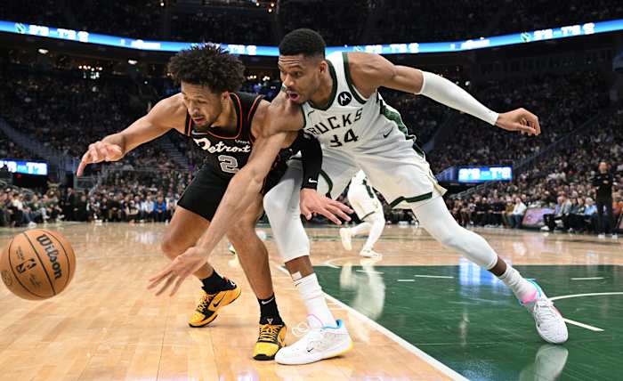 Detroit Pistons guard Cade Cunningham (2) and Milwaukee Bucks forward Giannis Antetokounmpo (34)